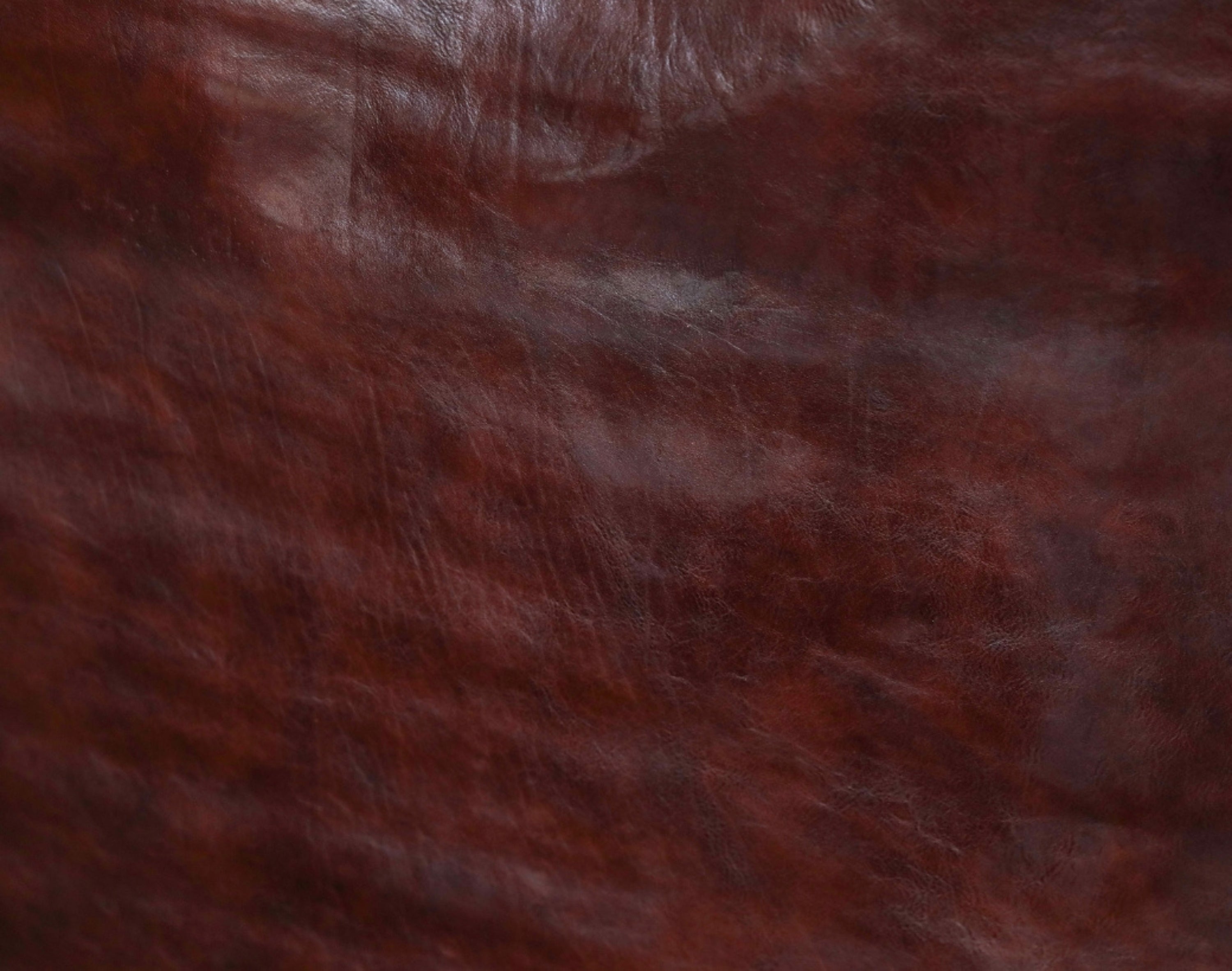 Leather surface with visible texture, wrinkles, and natural imperfections