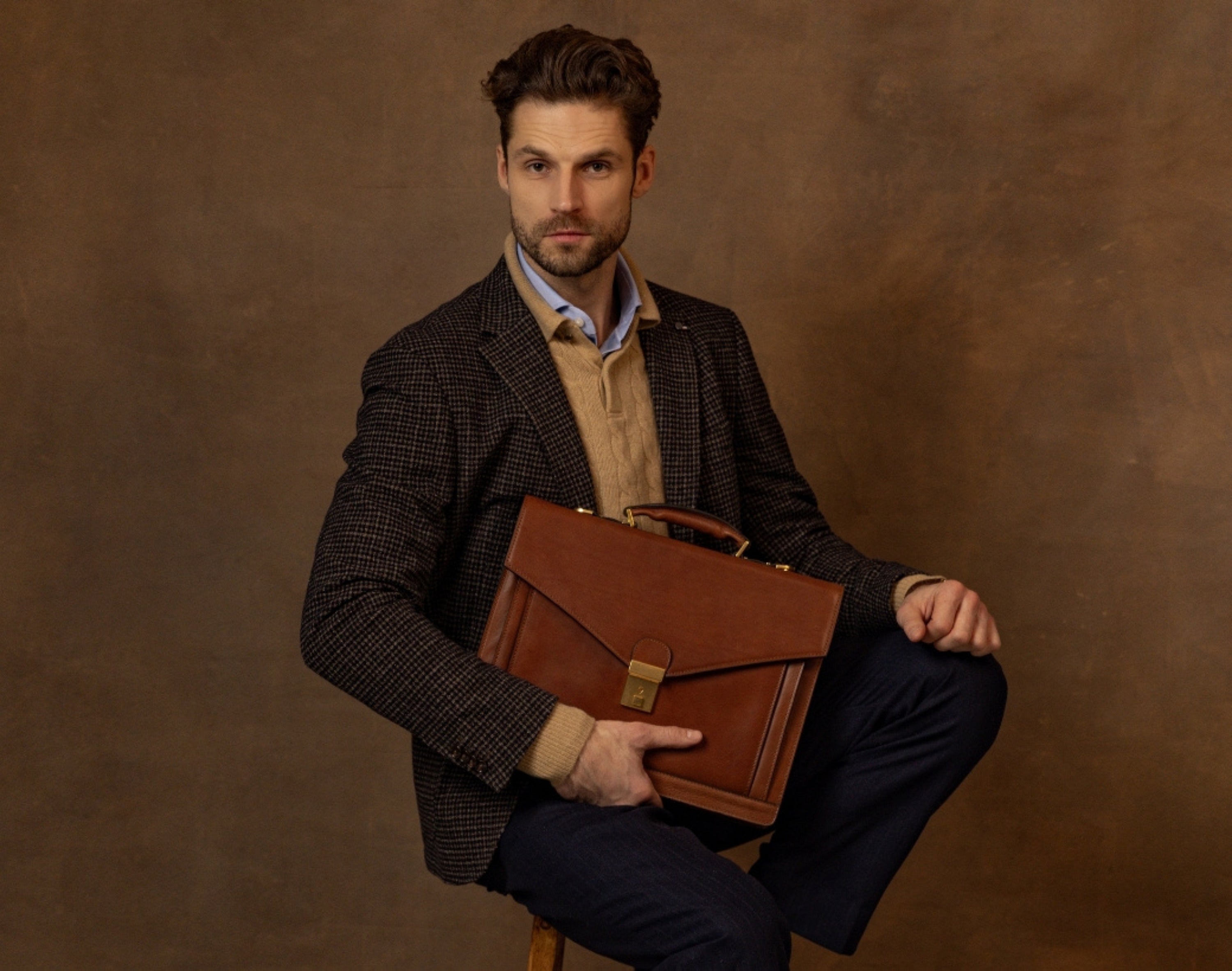 Man holding a full-grain leather briefcase