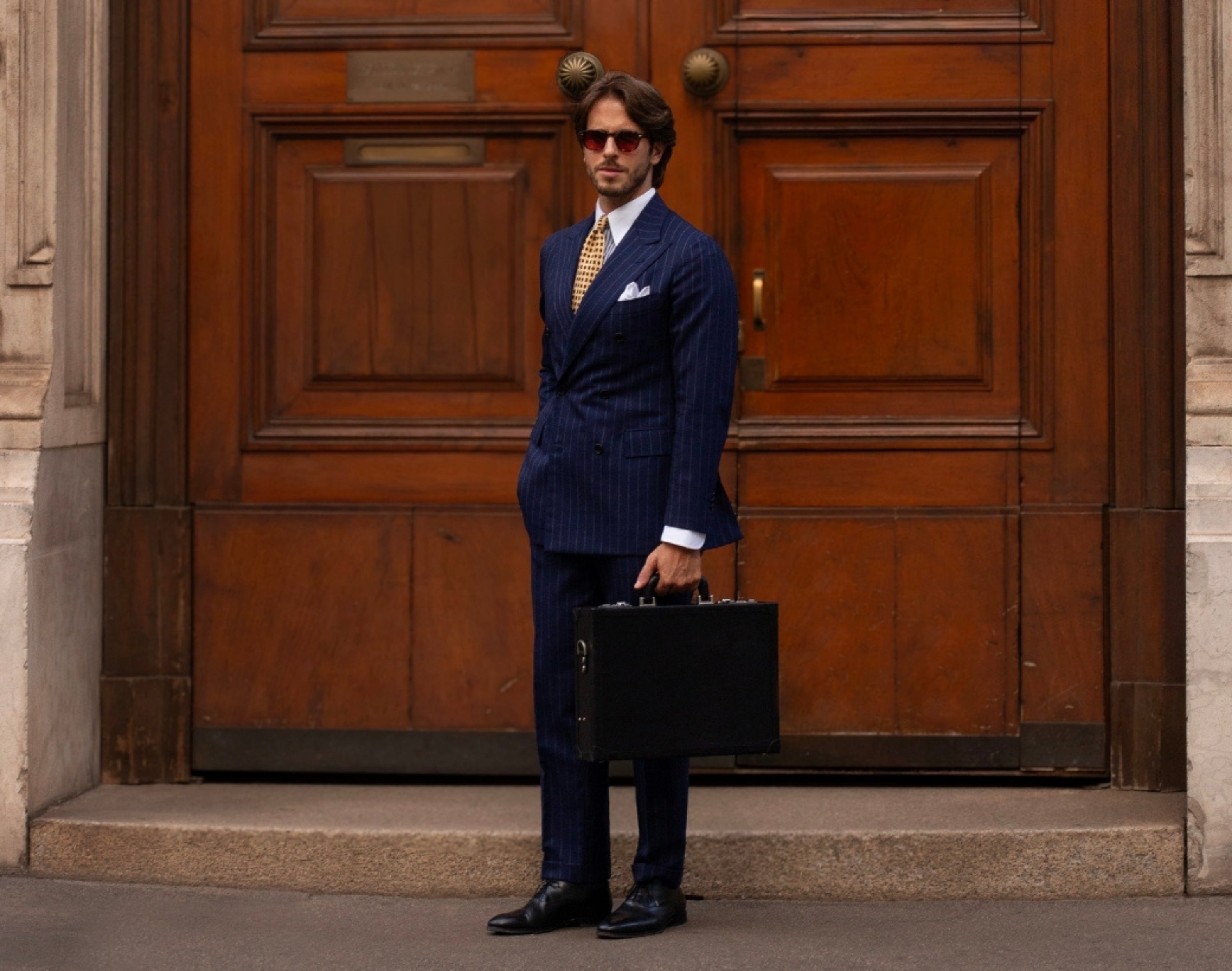 Man standing with a full-grain leather briefcase