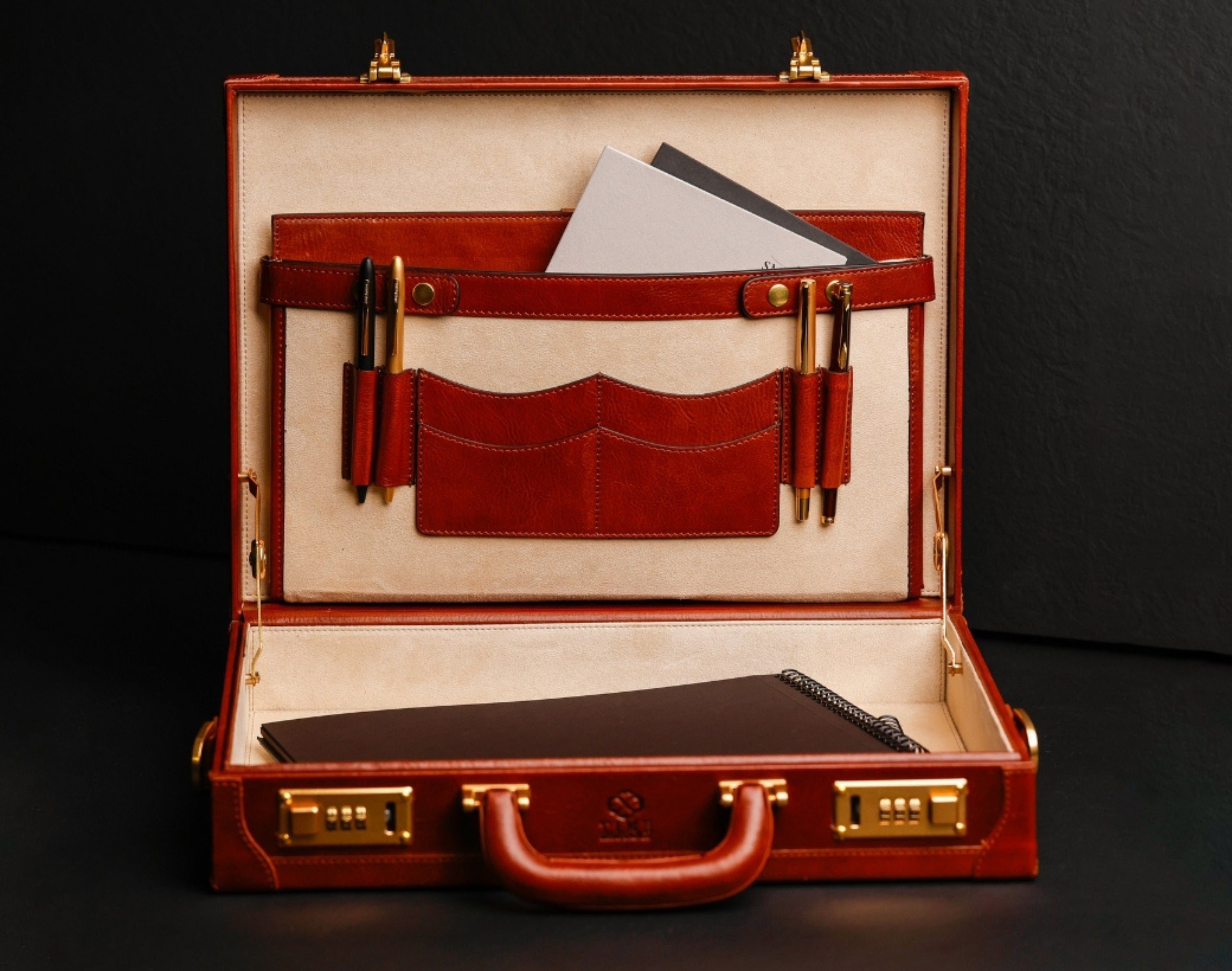 Open leather briefcase with items inside