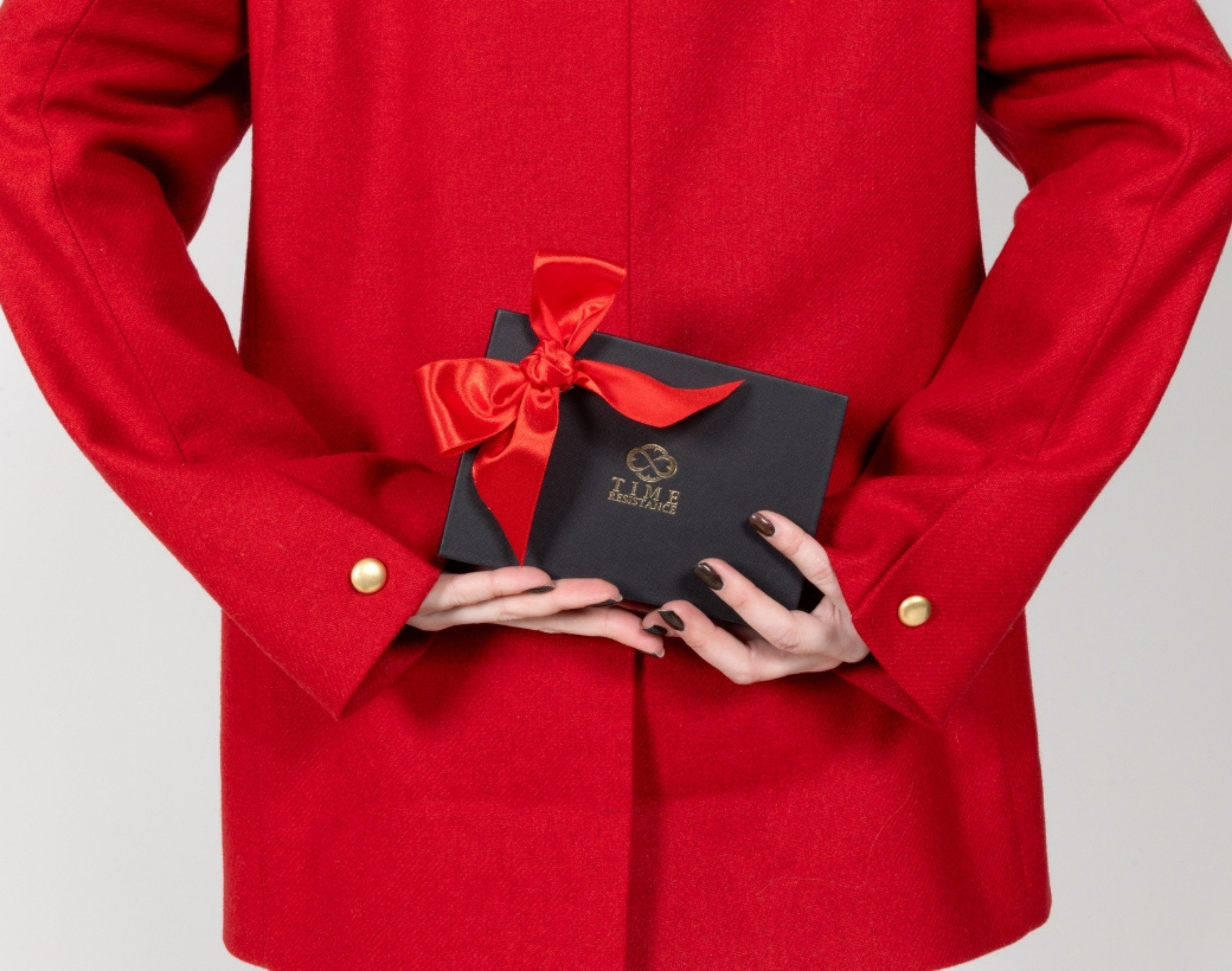 Woman holding a Time Resistance gift box behind her back