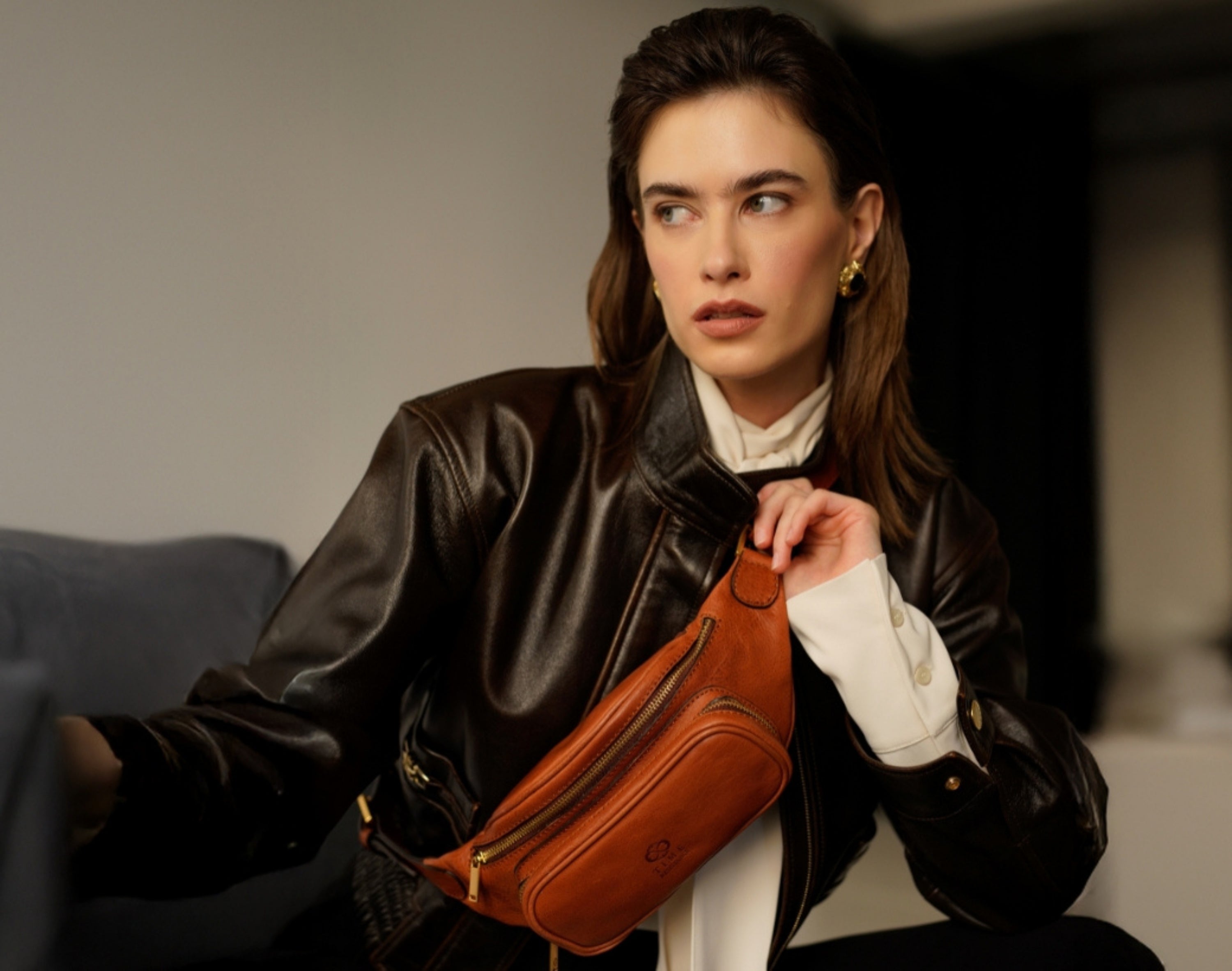 Woman wearing leather sling bag